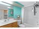 A well-maintained bathroom with a shower-tub combo, vanity, and bright turquoise accents at 2311 S Ocean Blvd. # 1125, Myrtle Beach, SC 29577