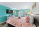 A relaxing bedroom featuring vibrant walls, a plush bed, and a flatscreen TV at 2311 S Ocean Blvd. # 1125, Myrtle Beach, SC 29577
