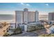 Beautiful coastal condo building with ocean views, parking, and tropical landscaping at 2311 S Ocean Blvd. # 1125, Myrtle Beach, SC 29577