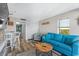 Living room displaying a blue sofa, breakfast table, and kitchen access at 2311 S Ocean Blvd. # 1125, Myrtle Beach, SC 29577