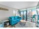 Living room with blue sofa and balcony featuring ocean view and seating at 2311 S Ocean Blvd. # 1125, Myrtle Beach, SC 29577