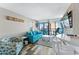 Cozy living room featuring a blue sofa, accent chair, and balcony access at 2311 S Ocean Blvd. # 1125, Myrtle Beach, SC 29577