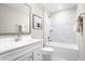 Bright bathroom featuring a tiled shower-tub combo, white vanity, and neutral color palette at 2343 Elowen Ln. # 11D, Longs, SC 29568