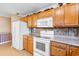 Kitchen with oak cabinets and white appliances at 305 21St Ave. S # 108, Myrtle Beach, SC 29577