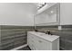 Bathroom featuring double sinks with a large mirror, vanity, wood paneling, and modern light fixtures at 447 Bragdon Ave., Georgetown, SC 29440