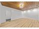 Large bedroom showcasing wood ceiling, plank floors, and doors leading to another room or closet at 447 Bragdon Ave., Georgetown, SC 29440
