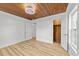 Bedroom with wood ceiling, stylish light fixture, wood floors and doors leading to the closet and hallway at 447 Bragdon Ave., Georgetown, SC 29440
