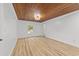 Bedroom features wood-paneled ceiling, hardwood floors, neutral paint and window with neighborhood view at 447 Bragdon Ave., Georgetown, SC 29440