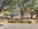 Single-story home with gray siding and a walkway, shaded by mature trees in a tranquil neighborhood at 447 Bragdon Ave., Georgetown, SC 29440