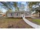 Charming single-story home featuring gray siding, white trim, and a welcoming front porch at 447 Bragdon Ave., Georgetown, SC 29440