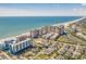 Expansive aerial view of a coastal town featuring ocean, residential buildings, and the beach at 4800 S Ocean Blvd. # 1219, North Myrtle Beach, SC 29582