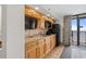 Efficient kitchen space with wooden cabinets, a microwave, and access to a balcony at 4800 S Ocean Blvd. # 1219, North Myrtle Beach, SC 29582