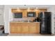 A well-equipped kitchen featuring wood cabinetry and a full-size refrigerator at 4800 S Ocean Blvd. # 1219, North Myrtle Beach, SC 29582
