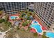 Aerial shot showcasing multiple pools, verdant landscaping, and resort-style leisure spaces at 4800 S Ocean Blvd. # 1219, North Myrtle Beach, SC 29582