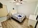 This bedroom features a queen bed, dresser, light colored walls, and wood-look floors at 6001 - 1045 S Kings Hwy., Myrtle Beach, SC 29575