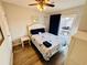 This bedroom features a queen bed with balcony access, light colored walls, and a ceiling fan at 6001 - 1045 S Kings Hwy., Myrtle Beach, SC 29575