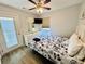 Bedroom with coastal themed comforter, ceiling fan, access to the balcony, and plenty of natural light at 6001 - 1045 S Kings Hwy., Myrtle Beach, SC 29575