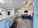Open-concept living space with modern kitchen, sleek bar seating, and a comfortable lounge area at 6001 - 1045 S Kings Hwy., Myrtle Beach, SC 29575