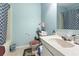 Cozy bathroom with light blue walls, patterned shower curtain, and simple white vanity at 815 Rogers Dr., Myrtle Beach, SC 29577