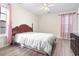 Bedroom with wood-look floors, a white ceiling fan, and natural lighting at 815 Rogers Dr., Myrtle Beach, SC 29577