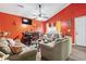 Bright living room with orange accent wall, vaulted ceiling and a ceiling fan at 815 Rogers Dr., Myrtle Beach, SC 29577
