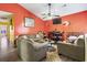 Comfortable living room with vibrant orange walls, vaulted ceilings and stylish decor at 815 Rogers Dr., Myrtle Beach, SC 29577