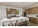 Modern kitchen with an island, white quartz countertops, and wooden cabinets at 882 Foxtail Dr. # C-38, Longs, SC 29568