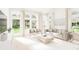 Bright and airy living room with large windows and neutral furniture at 890 Foxtail Dr. # D-40, Longs, SC 29568