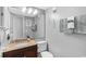 Cozy bathroom featuring a wooden vanity, neutral paint and decor and a large mirror at 9400 Shore Dr. # 312, Myrtle Beach, SC 29572