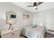 Relaxing bedroom with a comfortable bed, dresser, ceiling fan, and warm ambiance at 9400 Shore Dr. # 312, Myrtle Beach, SC 29572