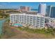 Exterior view of a condo building with a pool and hot tub, providing resort-style living with ocean views at 9400 Shore Dr. # 312, Myrtle Beach, SC 29572