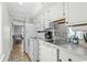 Bright kitchen with white appliances and countertop, offering essential amenities at 9400 Shore Dr. # 312, Myrtle Beach, SC 29572