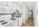Efficient kitchen with white appliances, ample cabinet space, and tiled flooring at 9400 Shore Dr. # 312, Myrtle Beach, SC 29572