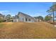 Backyard with a view of a stream, and back exterior of home at 158 Regency Dr., Conway, SC 29526