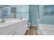 A renovated bathroom featuring new vanity, mirror and a tub at 158 Regency Dr., Conway, SC 29526