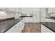 Modern kitchen featuring white cabinets, granite countertops, and all white appliances with hardwood floors at 158 Regency Dr., Conway, SC 29526
