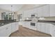 Well-equipped kitchen featuring white cabinets, granite countertops, a modern microwave, and matching appliances at 158 Regency Dr., Conway, SC 29526