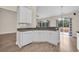 Bright kitchen featuring white cabinets, granite countertops, stainless steel sink and hardwood floors at 158 Regency Dr., Conway, SC 29526