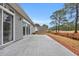 A tiled stone patio with sliding glass doors and treelined view at 158 Regency Dr., Conway, SC 29526