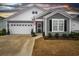 Gray and white two-story house with a two-car garage and landscaping at 2548 Brescia St., Myrtle Beach, SC 29579