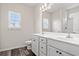 Bright bathroom with dual sink vanity, large mirror, and natural light from two windows at 332 Hayloft Circle, Conway, SC 29526