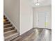 Welcoming entryway featuring wood-look flooring, staircase, and front door with sidelights for added light at 332 Hayloft Circle, Conway, SC 29526