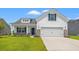 Charming two-story home featuring a two-car garage, well-maintained lawn, and covered front porch at 332 Hayloft Circle, Conway, SC 29526