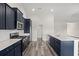Modern kitchen features navy cabinets, stainless steel appliances, and white countertops at 332 Hayloft Circle, Conway, SC 29526