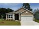 Charming single-story home with a two-car garage, and a welcoming front lawn and meticulously maintained landscaping at 503 Slaty Dr., Myrtle Beach, SC 29588
