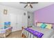 Purple-walled bedroom with double bed and TV at 624 Watercliff Dr., Longs, SC 29568