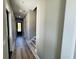 Bright hallway with wood-look floors and access to stairs at 825 Commanders Island Dr., Georgetown, SC 29440