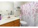 Clean bathroom with shower/tub and floral shower curtain at 1204 Erin Way # 1204-F, Myrtle Beach, SC 29577