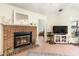 Brick fireplace with a fire burning at 1204 Erin Way # 1204-F, Myrtle Beach, SC 29577