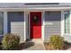 Red front door with wreath and gray siding at 1204 Erin Way # 1204-F, Myrtle Beach, SC 29577